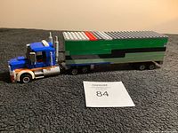 Full side view of the LEGO transport truck showing complete trailer and cab with MaxSold lot number card.