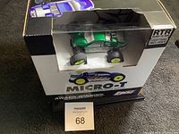 Losi Micro T green body RC truck in original packaging with visible plastic window showing front and side of vehicle.