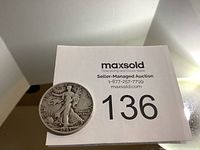 Front and detail view of the 1943 US Walking Liberty half dollar coin showing the walking Liberty design and date.