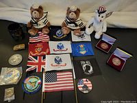 Photo of the entire assortment showing teddy bears, rabbit, flags, coins, pins, belt buckle, mug, patches.