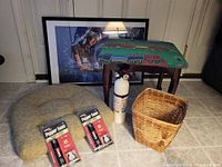 Photo of all items including framed puzzle, foot stool, fire extinguisher, pepper foam spray packages, woven basket and seat cushion