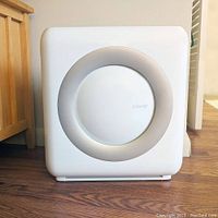 Front view of the Coway Airmega HEPA Air Purifier showing circular central air outlet and white plastic casing.