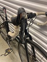 Full side view of the black Specialized touring bicycle showing frame, handlebars, saddle and rear rack