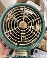 Close-up top view of the green Vornado VFAN Jr. Vintage Air Circulator Fan grille and blades.