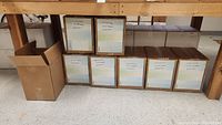 Eight boxes of multi-coloured 4DRS branded paper lined up under a table, showing box labels with color descriptions and quantities.