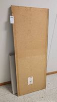 Back/underside of largest laminate countertop piece showing particleboard material and label.