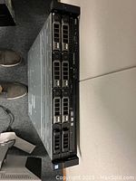 Front view of server showing eight 2.5-inch hot-swappable drive bays, front I/O ports, power button and status LEDs.