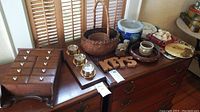 Overview photo showing all items on wooden furniture: barometer set, wooden hanging organizer, baskets, planters, animal figurines, and decor pieces.
