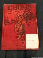 Red hardcover book titled 'Chums' showing the front cover with cowboy and horse drawing and a note with dates 1930-1931.