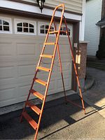 Orange 8-step aluminum ladder fully extended, showing overall height and step spacing.