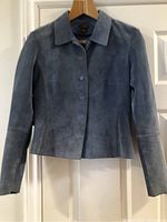 Front view of blue-gray leather jacket hanging on wooden hanger showing full front length and design details.