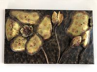 Full view of the handmade metal botanical wall art, showing leaves and flower details with weathered paint on a rectangular base.