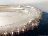 Close-up image showing detailed ornate scalloped and ridged edge with beaded trim of silver plated tray.