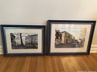 Pair of framed watercolour prints by Norman Hayes showing Oxfordshire scenes, each in dark wooden frames with a mat and glass.