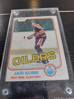 Front of 1981 O-Pee-Chee Jari Kurri hockey card in protective case showing player in Oilers uniform.