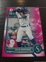 Front view of Bowman Julio Rodriguez baseball card numbered 124/299 showing player in batting stance with pink border.