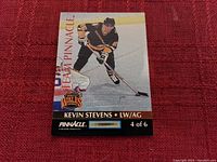 Clear photo of Kevin Stevens Pinnacle hockey card showing front with player in Pittsburgh Penguins jersey, Team Pinnacle branding, Prince of Wales Conference logo and card details.