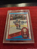 Close-up photo of O-Pee-Chee Brian Leetch Calder Trophy hockey card in protective sleeve.