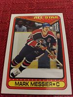 Photo of a Topps All Star hockey card showing Mark Messier in Edmonton Oilers uniform on ice rink.