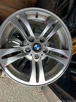 Top view of one BMW aluminum alloy wheel showing the bird's-eye multi-spoke design and BMW emblem at center mount.