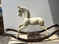 Full side view of the vintage wooden rocking horse showing the overall structure and size.