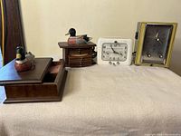 Overview of all four items including two clocks and duck themed wooden set