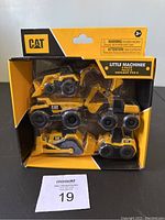 Front view of sealed CAT Little Machines 5 pack with visible 5 yellow and black construction vehicle toys in original box.