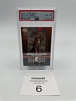 Front view of the 2003 Upper Deck Dwyane Wade Rookie Exclusives basketball card graded PSA 8 in a protective case.
