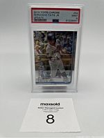 Front view of the graded card showing Fernando Tatis Jr in batting pose with Padres uniform and official grading slab showing PSA 9 grade.