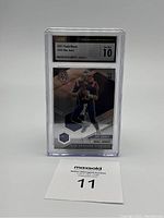 Front view of the graded Mac Jones rookie card in a protective slab with label showing grading and details.