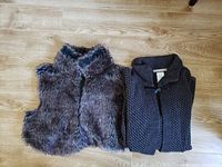 Photo showing both the brown faux fur vest and the dark gray wool cardigan folded side-by-side on a wooden floor.