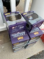 Stack of Guardians of the Galaxy Dorbz vinyl figure boxes, showing packaging with brand and series names visible.