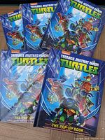Five Teenage Mutant Ninja Turtles pop-up books in blue packaging, featuring the turtles in action poses on the cover.