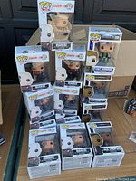 Photo showing majority of the lot including stacked boxes of Markov figures and other Funko Pop boxes in a cardboard box.