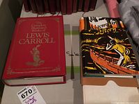 Photo showing the front covers of the two books in the lot: The Complete Illustrated Works of Lewis Carroll and Algonquin Story with accompanying maps.