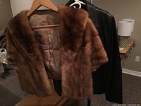 Vintage genuine mink fur stole on hanger showing fur texture and satin lining