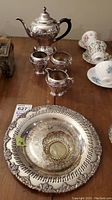 Overview of entire tea set and additional serving dishes on table