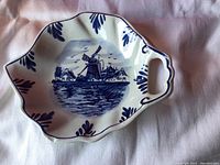 Top view of the candy dish showing the windmill scene and leaf pattern around the edge.