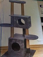 Photo of the assembled five level cat tree condo showing multiple platforms, enclosed condos with entry holes, and scratching posts.