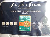 Packaged label image showing the brand SmartSilk, 100% silk lined pillows in a 2 pack, certified asthma and allergy friendly.