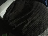 Overall view of large, round, dark brown corduroy fabric dog bed.