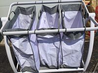 Front view of the hamper frame with three attached fabric hampers