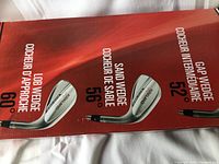 Photo showing the product labeling for each wedge including loft degrees: Lob Wedge 60°, Sand Wedge 56°, Gap Wedge 52°. All wedges have 'MaxSold' branding.