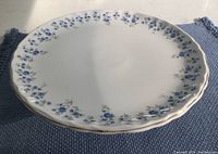 Top view of the cake plate showing the Memory Lane blue floral pattern on the scalloped white china plate with gold trim.