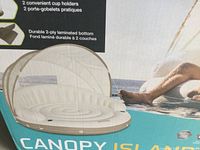 Box front showing Intex Canopy Island inflatable float with canopy, highlights 2 cup holders and durable 2-ply laminated bottom