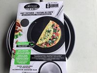 Gotham Pro branded packaging showing an image of a filled omelette in a skillet, highlighting the cast textured non-stick surface and hard anodized aluminum construction.