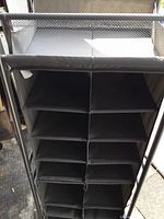 Front view of the shoe rack showing 14 enclosed cubby holes in two vertical columns.