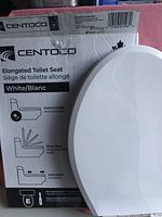 Photo of Centoco elongated toilet seat box showing product features: antimicrobial, slow close, adjustable. White toilet seat partially visible leaning against the box.
