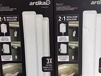 Front packaging showing the Artika Maestro LED under cabinet light kit with three LED panels per box and dual installation method.