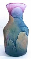 Front view of hand painted glass vase showing colorful flowing abstract pattern and flared rim.